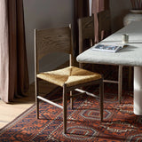 A seamless addition to your dining collection, a slim-profile dining chair pairs a woven banana leaf seat with a solid oak frame featuring a bentwood back Amethyst Home provides interior design, new home construction design consulting, vintage area rugs, and lighting in the Winter Garden metro area.