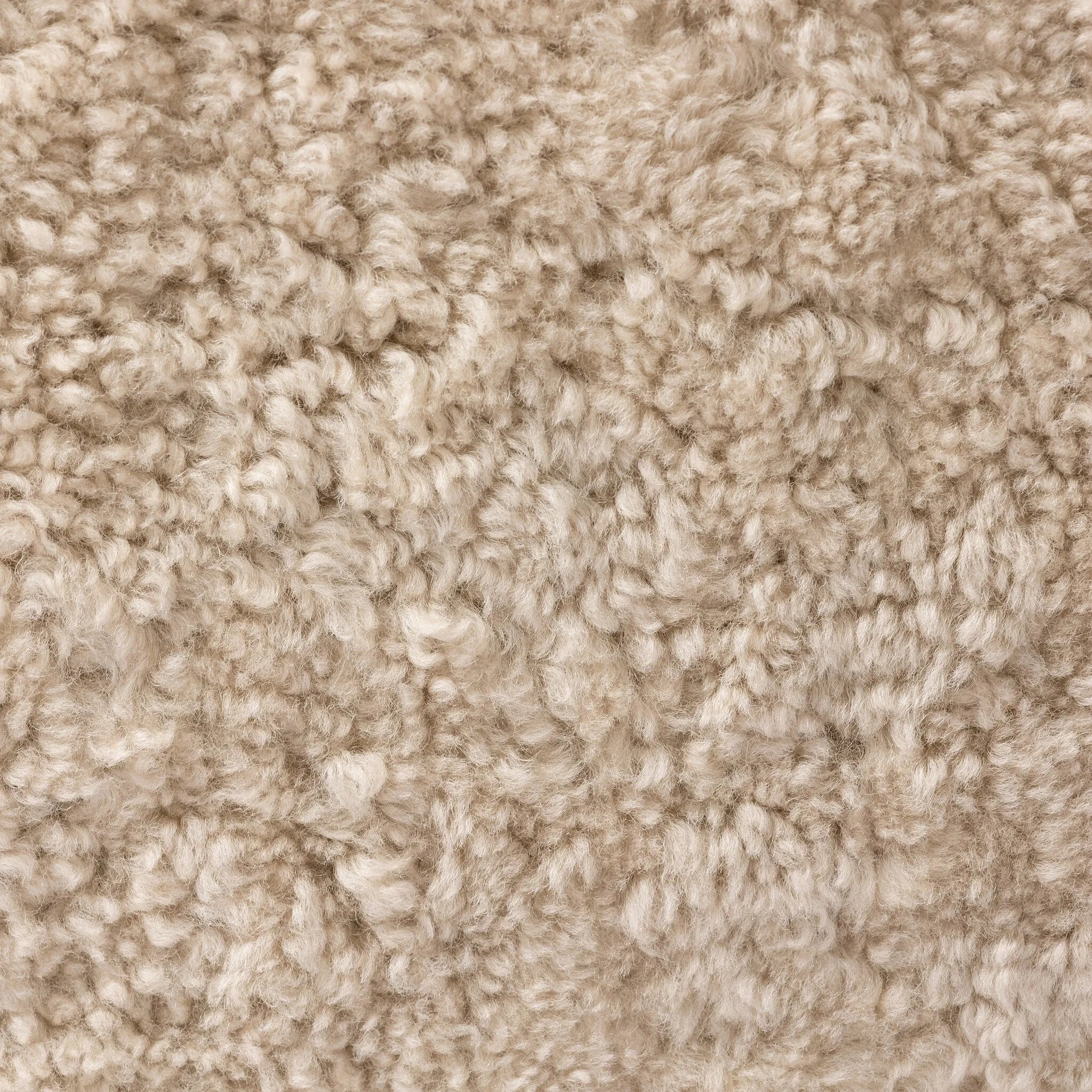 With a supple pile that's soft to the touch, taupe shearling upholstery pairs with an S-spring seat and enveloped frame for an inviting look and feel on this 360-degree swivel chair Amethyst Home provides interior design, new home construction design consulting, vintage area rugs, and lighting in the Austin metro area.