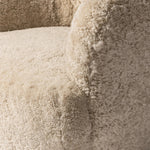 With a supple pile that's soft to the touch, taupe shearling upholstery pairs with an S-spring seat and enveloped frame for an inviting look and feel on this 360-degree swivel chair Amethyst Home provides interior design, new home construction design consulting, vintage area rugs, and lighting in the Charlotte metro area.