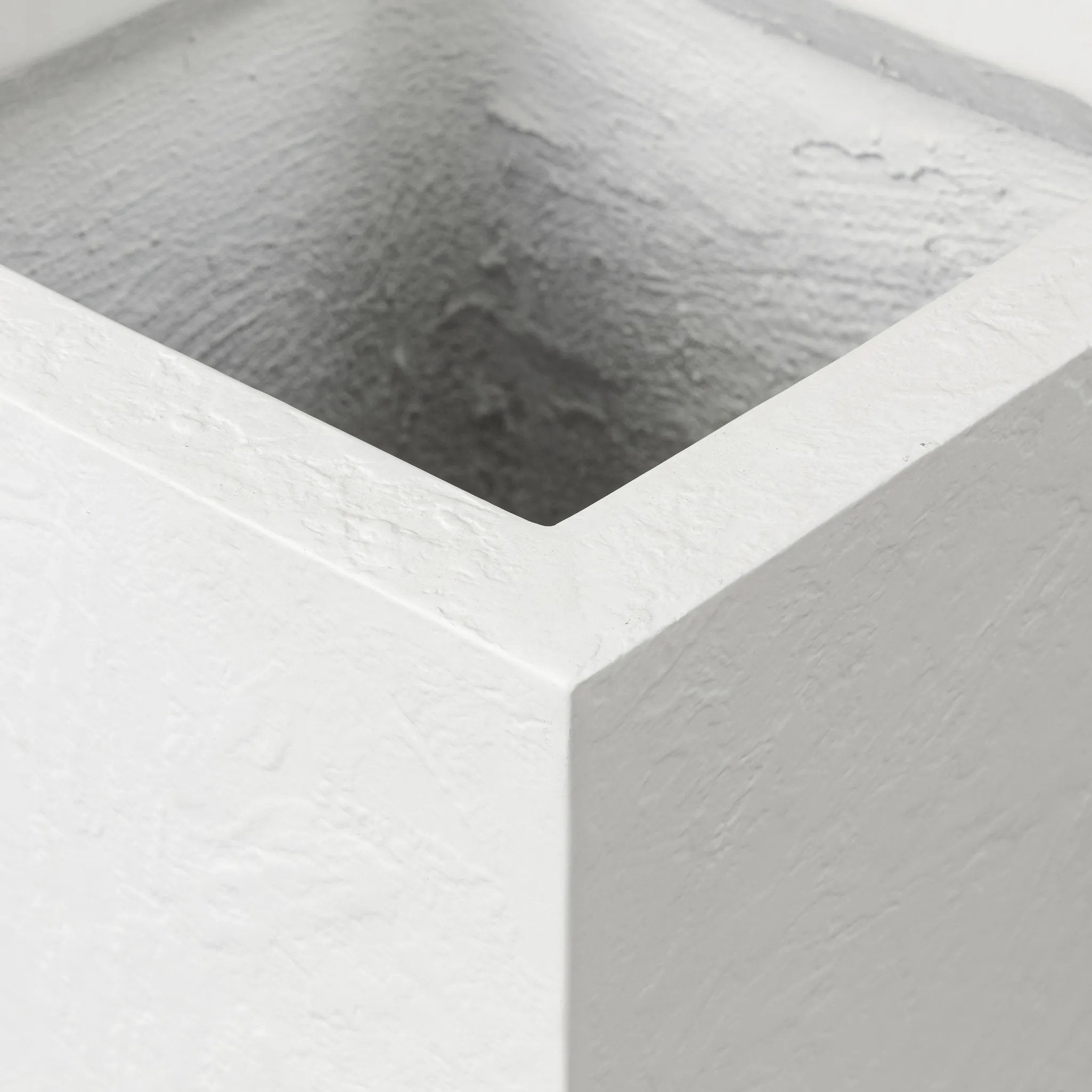 Cast black concrete forms a monolithic planter for use indoors and out. Cover or store indoors during inclement weather and when not in use Amethyst Home provides interior design, new home construction design consulting, vintage area rugs, and lighting in the Seattle metro area.