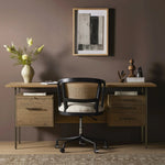 Featuring Lauren Natural Resawn Oak Desk by Four Hands at Amethyst Home. Made from solid oak and reclaimed peroba, a legal-style desk offers major storage with dual cabinetry, including file storage for legal and letter-size documents. A floating top and iron legs keep the look modern and light. This piece is designed in collaboration with Thomas Bina. Four H. Amethyst Home provides interior design, new home construction design consulting, vintage area rugs, and lighting in the Houston metro area.