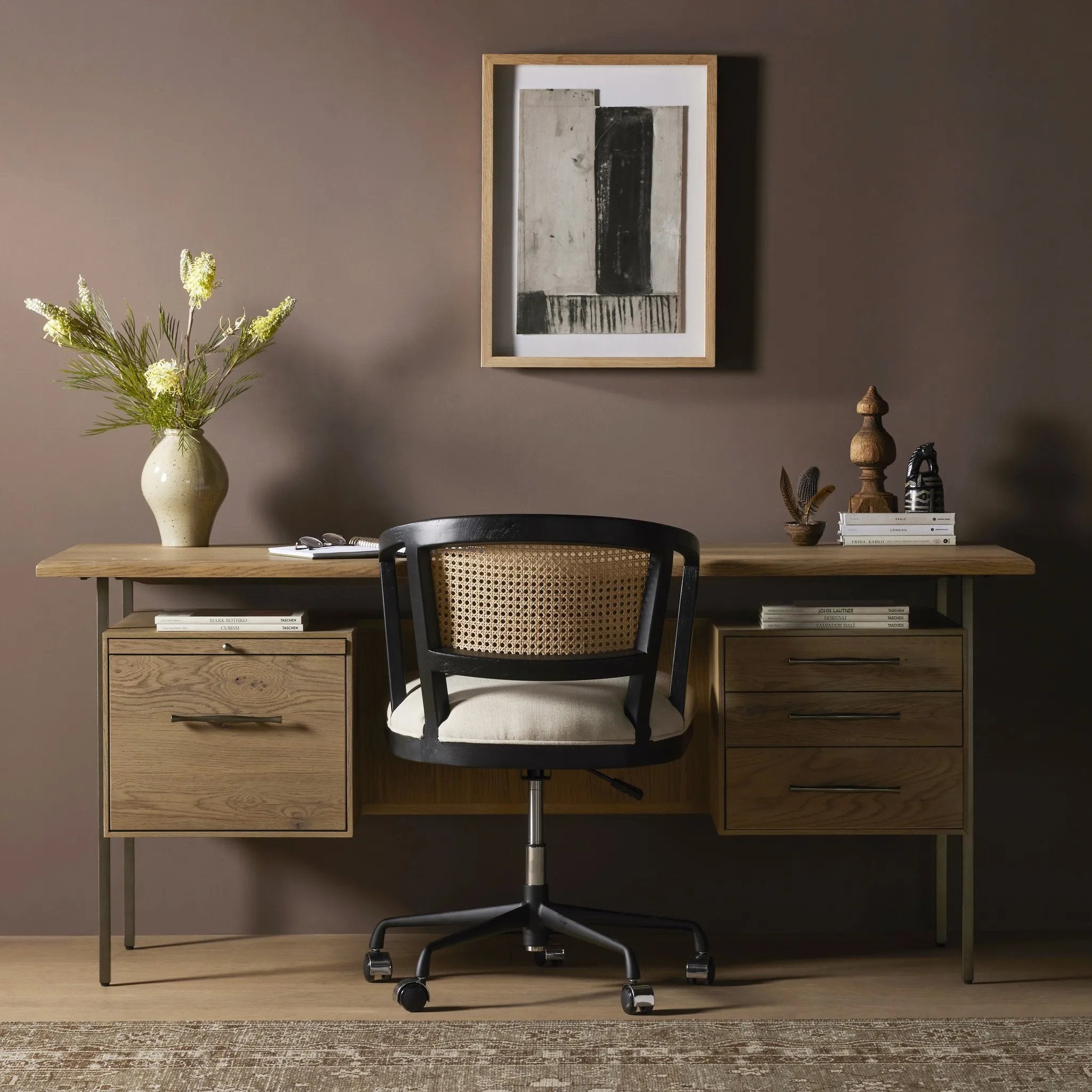 Featuring Lauren Natural Resawn Oak Desk by Four Hands at Amethyst Home. Made from solid oak and reclaimed peroba, a legal-style desk offers major storage with dual cabinetry, including file storage for legal and letter-size documents. A floating top and iron legs keep the look modern and light. This piece is designed in collaboration with Thomas Bina. Four H. Amethyst Home provides interior design, new home construction design consulting, vintage area rugs, and lighting in the Houston metro area.