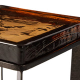 An airy, angular base of charcoal-burnished iron supports a squared tabletop of amber cast glass, perfectly sized to keep your drink or book within reach Amethyst Home provides interior design, new home construction design consulting, vintage area rugs, and lighting in the Austin metro area.
