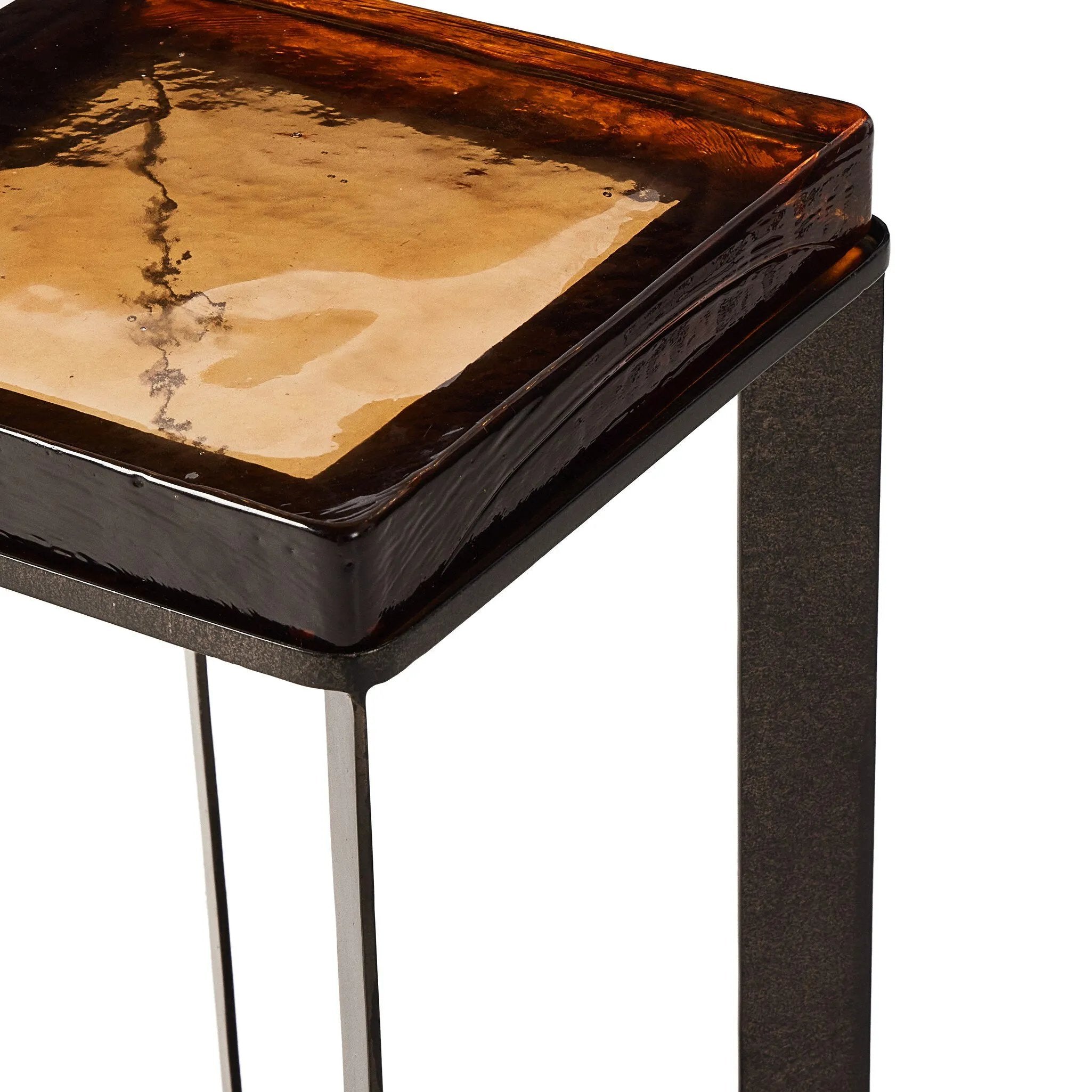 An airy, angular base of charcoal-burnished iron supports a squared tabletop of amber cast glass, perfectly sized to keep your drink or book within reach Amethyst Home provides interior design, new home construction design consulting, vintage area rugs, and lighting in the Scottsdale metro area.