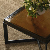 An airy, angular base of charcoal-burnished iron supports a squared tabletop of amber cast glass, perfectly sized to keep your drink or book within reach. Styles well alone or paired in multiples.Collection: Marlo Amethyst Home provides interior design, new home construction design consulting, vintage area rugs, and lighting in the Los Angeles metro area.