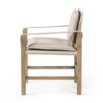 Inspired by a vintage safari-style frame, this dining chair is defined by the fluid strap arms. Semi-attached cushions in taupe performance fabric, finished with button tufting details. Framed out by warm parawood. Amethyst Home provides interior design, new home construction design consulting, vintage area rugs, and lighting in the Calabasas metro area.