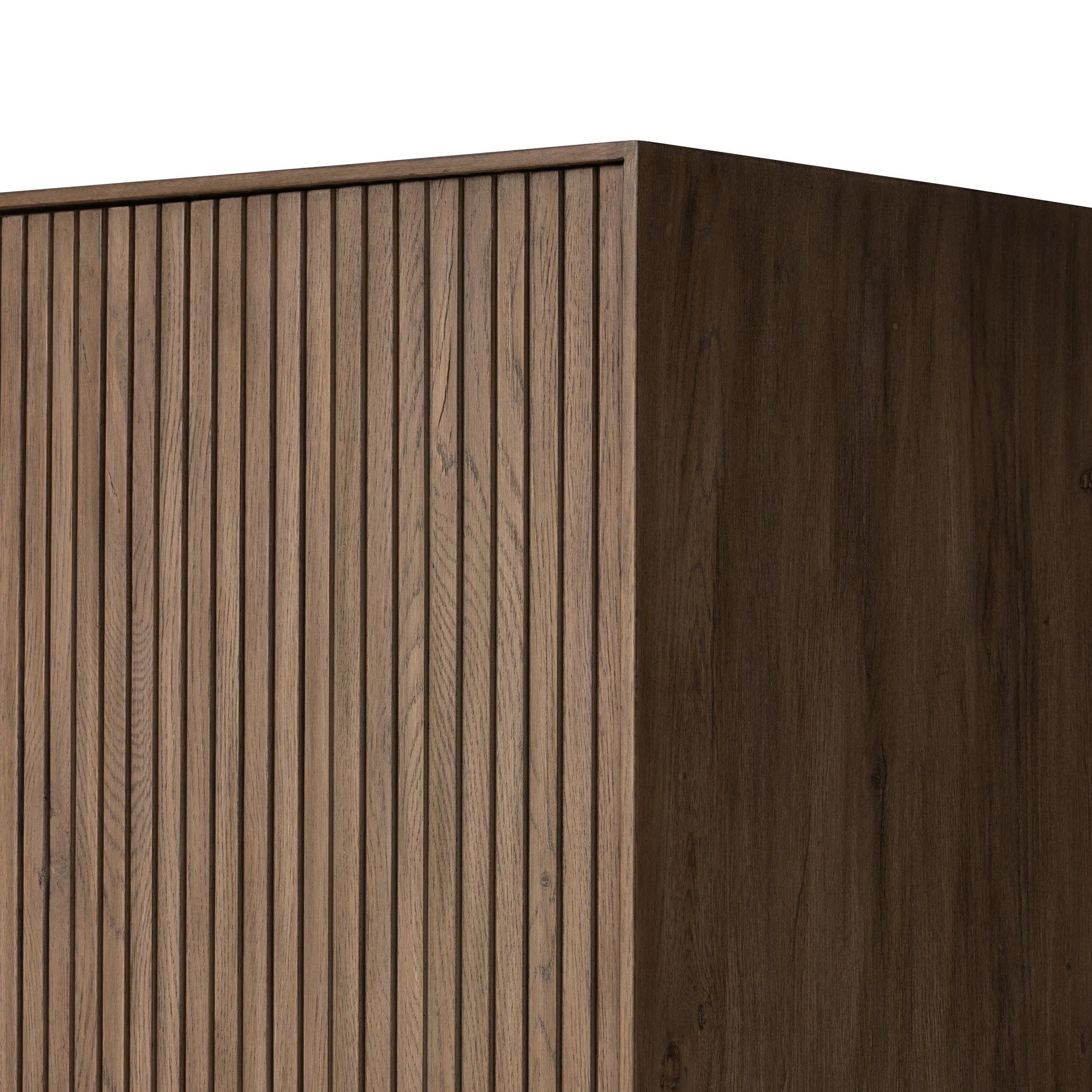 Made from rustic-finished oak with a plinth-style base, clean angles and linear reeding define this midcentury-spirited cabinet. Fully finished interior for a beautiful look inside and out. Designed in partnership with longtime Four Hands collaborator Thomas Bina and Brazilian designer Ronald Sasson. Amethyst Home provides interior design, new home construction design consulting, vintage area rugs, and lighting in the Miami metro area.