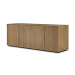 Made from rustic-finished oak with a plinth-style base, clean angles and linear reeding define this midcentury-spirited sideboard. Fully finished interior for a beautiful look inside and out. Designed in partnership with longtime Four Hands collaborator Thomas Bina and Brazilian designer Ronald Sasson Amethyst Home provides interior design, new home construction design consulting, vintage area rugs, and lighting in the Los Angeles metro area.