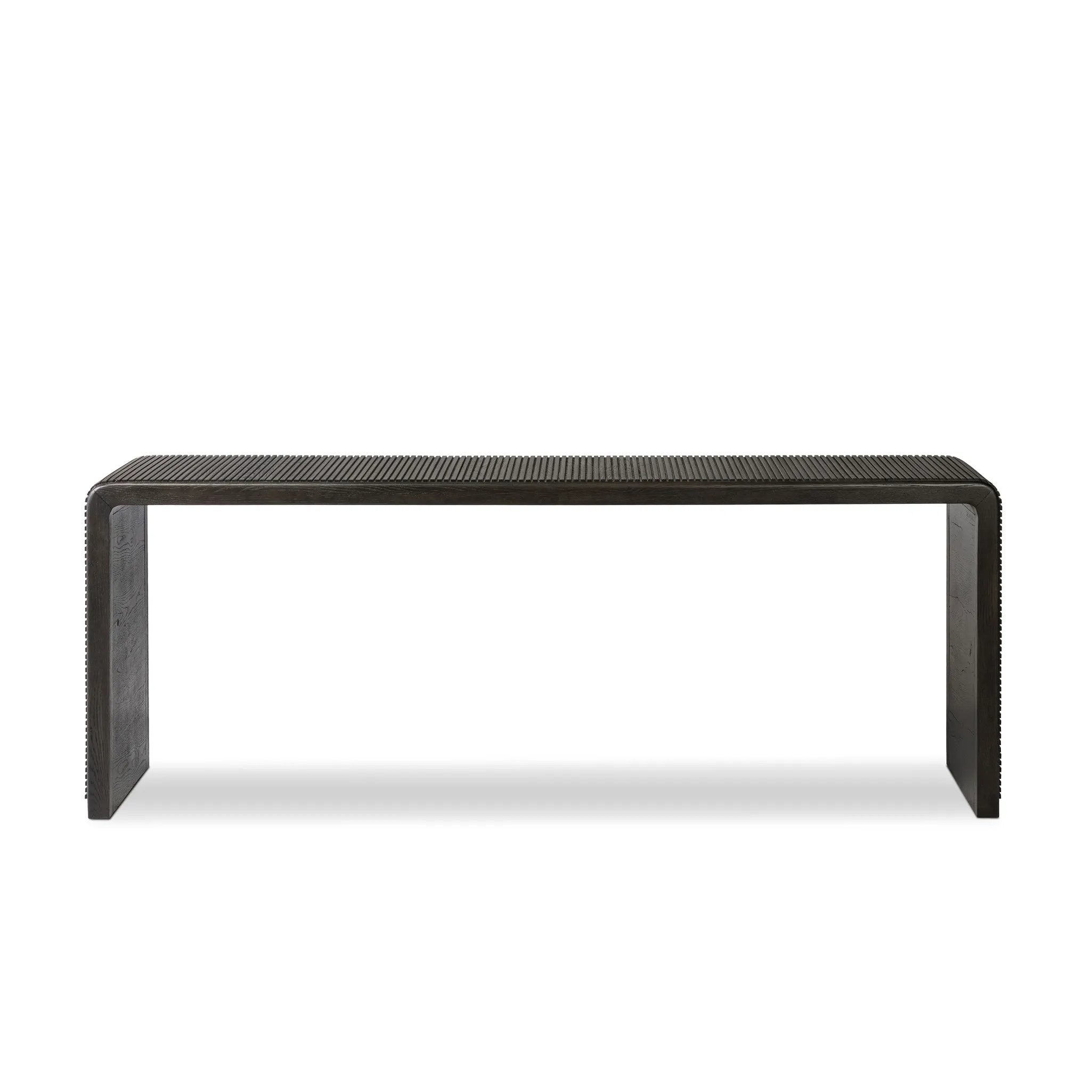 Smoked black oak shapes an elongated console table, rich with reeding. Subtly rounded edges reflect Brazilian midcentury inspiration behind this crafted minimalist piece. Designed in partnership with longtime Four Hands collaborator Thomas Bina and designer Ronald Sasson Amethyst Home provides interior design, new home construction design consulting, vintage area rugs, and lighting in the Boston metro area.