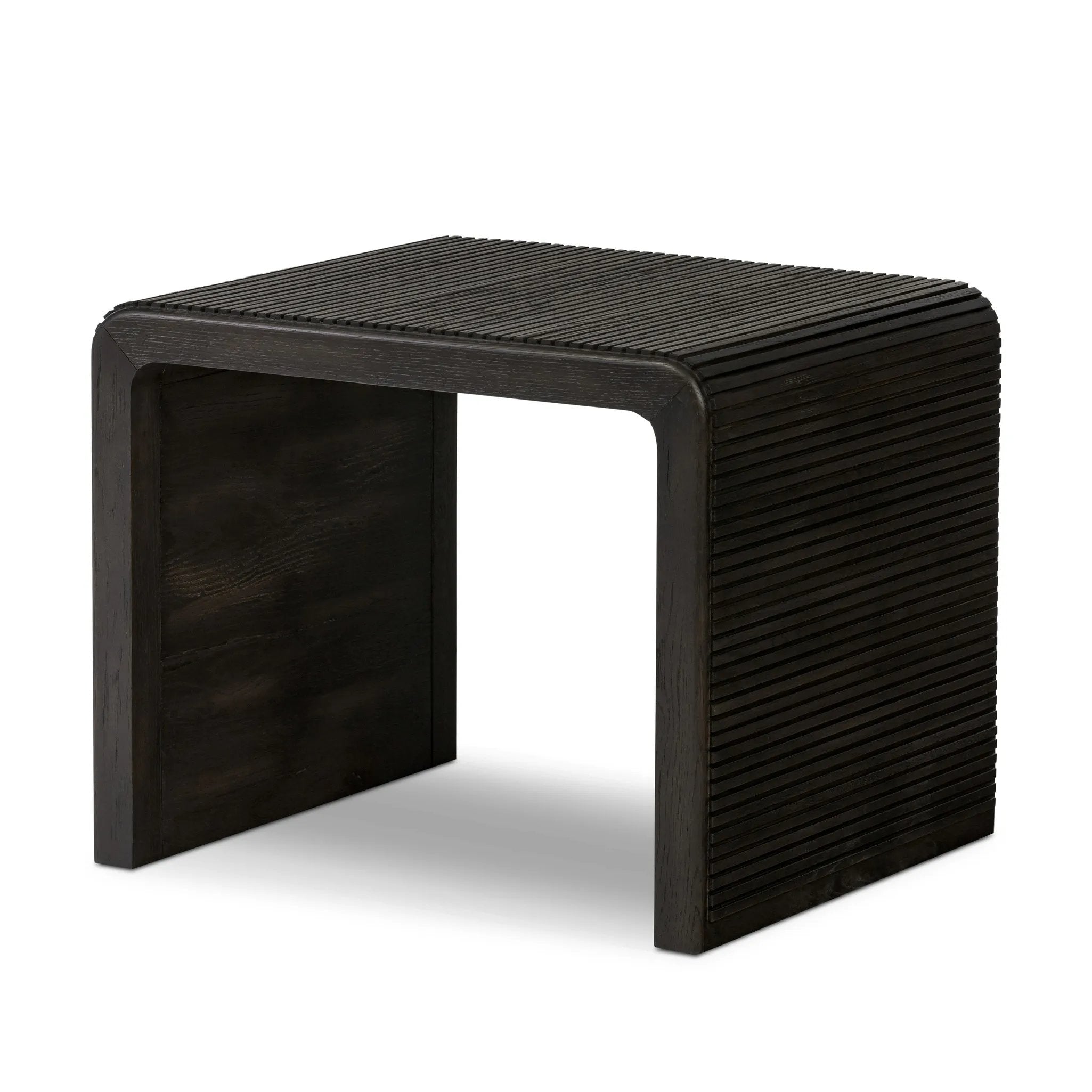 Made from smoked black oak, linear reeding and a curved shape define this midcentury-spirited end table. Designed in partnership with longtime Four Hands collaborator Thomas Bina and Brazilian designer Ronald Sasson Amethyst Home provides interior design, new home construction design consulting, vintage area rugs, and lighting in the Boston metro area.