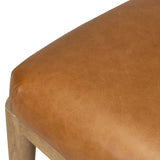 The barrel back dining chair, refreshed. Light oak shapes an armless frame and curved rear legs that almost appear to flow into the seat back. A comfy seat is upholstered in chestnut top-grain leather, while reeding details on the back create a sense of perception play. Amethyst Home provides interior design, new home construction design consulting, vintage area rugs, and lighting in the Los Angeles metro area.