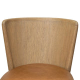 The barrel back dining chair, refreshed. Light oak shapes an armless frame and curved rear legs that almost appear to flow into the seat back. A comfy seat is upholstered in chestnut top-grain leather, while reeding details on the back create a sense of perception play. Amethyst Home provides interior design, new home construction design consulting, vintage area rugs, and lighting in the Monterey metro area.