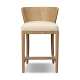 The barrel back counter stool, refreshed. Light oak shapes an armless frame and curved rear legs that almost appear to flow into the seat back. A comfy seat is upholstered in high-performance fabric, while reeding details create a sense of perception play. Amethyst Home provides interior design, new home construction design consulting, vintage area rugs, and lighting in the Houston metro area.