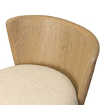 The barrel back counter stool, refreshed. Light oak shapes an armless frame and curved rear legs that almost appear to flow into the seat back. A comfy seat is upholstered in high-performance fabric, while reeding details create a sense of perception play. Amethyst Home provides interior design, new home construction design consulting, vintage area rugs, and lighting in the Park City metro area.