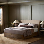 Clean lines meet contoured curves for a timeless bedroom look. A petal-shaped shelter overlaps side rails for a unique,  comforting silhouette. Fully upholstered in a versatile taupe that complements a wide range of color palettes, all grounded by a rich oak base Amethyst Home provides interior design, new home construction design consulting, vintage area rugs, and lighting in the Austin metro area.