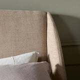 Clean lines meet contoured curves for a timeless bedroom look. A petal-shaped shelter overlaps side rails for a unique,  comforting silhouette. Fully upholstered in a versatile taupe that complements a wide range of color palettes, all grounded by a rich oak base Amethyst Home provides interior design, new home construction design consulting, vintage area rugs, and lighting in the Seattle metro area.