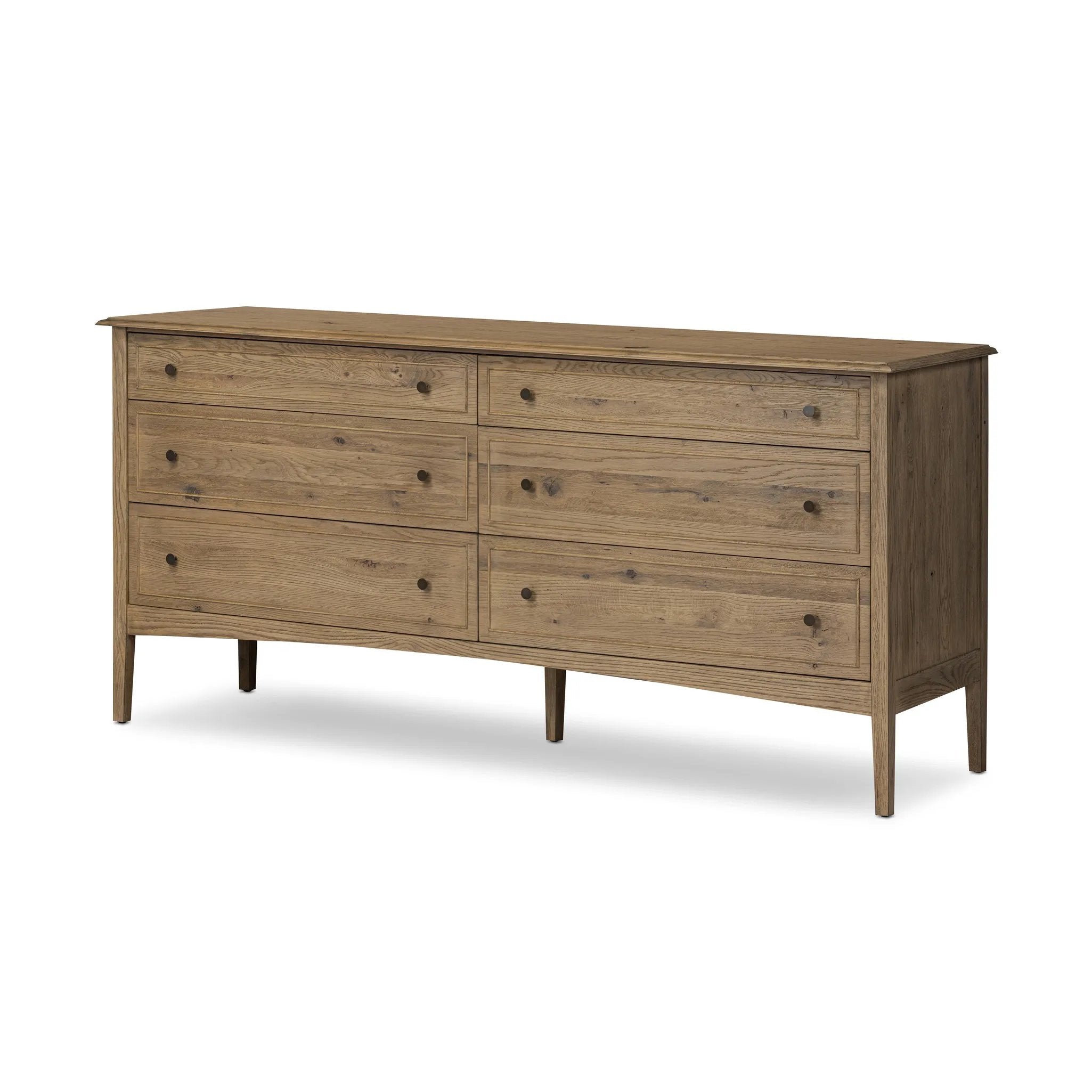 A cleanly shaped six-drawer dresser is crafted from aged smoked oak, highlighting the wood's natural grain. Roomy drawers offer plenty of space for bedroom storage, while the slim, tapered legs give the piece a subtle lift, creating a grounded look Amethyst Home provides interior design, new home construction design consulting, vintage area rugs, and lighting in the Newport Beach metro area.
