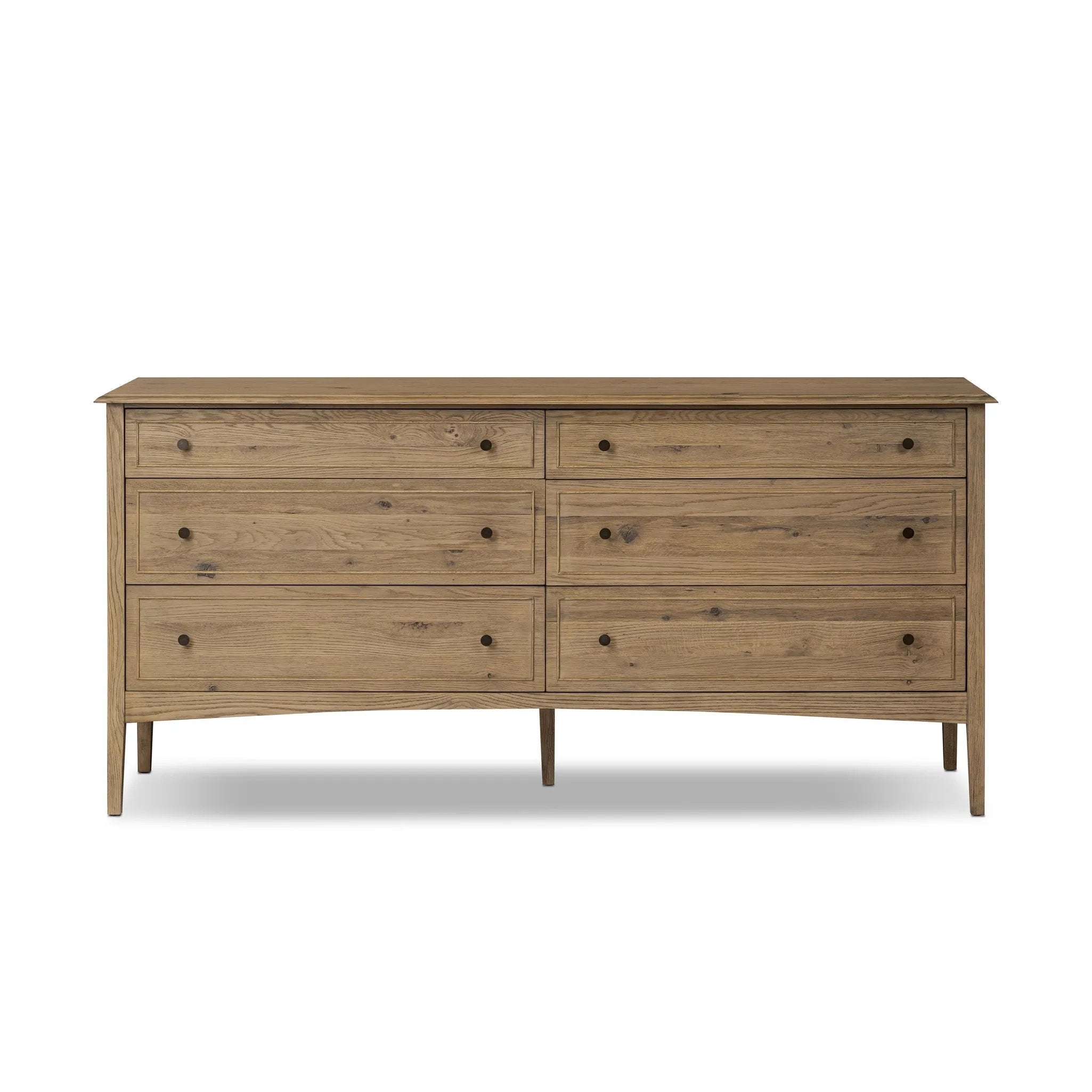 A cleanly shaped six-drawer dresser is crafted from aged smoked oak, highlighting the wood's natural grain. Roomy drawers offer plenty of space for bedroom storage, while the slim, tapered legs give the piece a subtle lift, creating a grounded look Amethyst Home provides interior design, new home construction design consulting, vintage area rugs, and lighting in the Salt Lake City metro area.