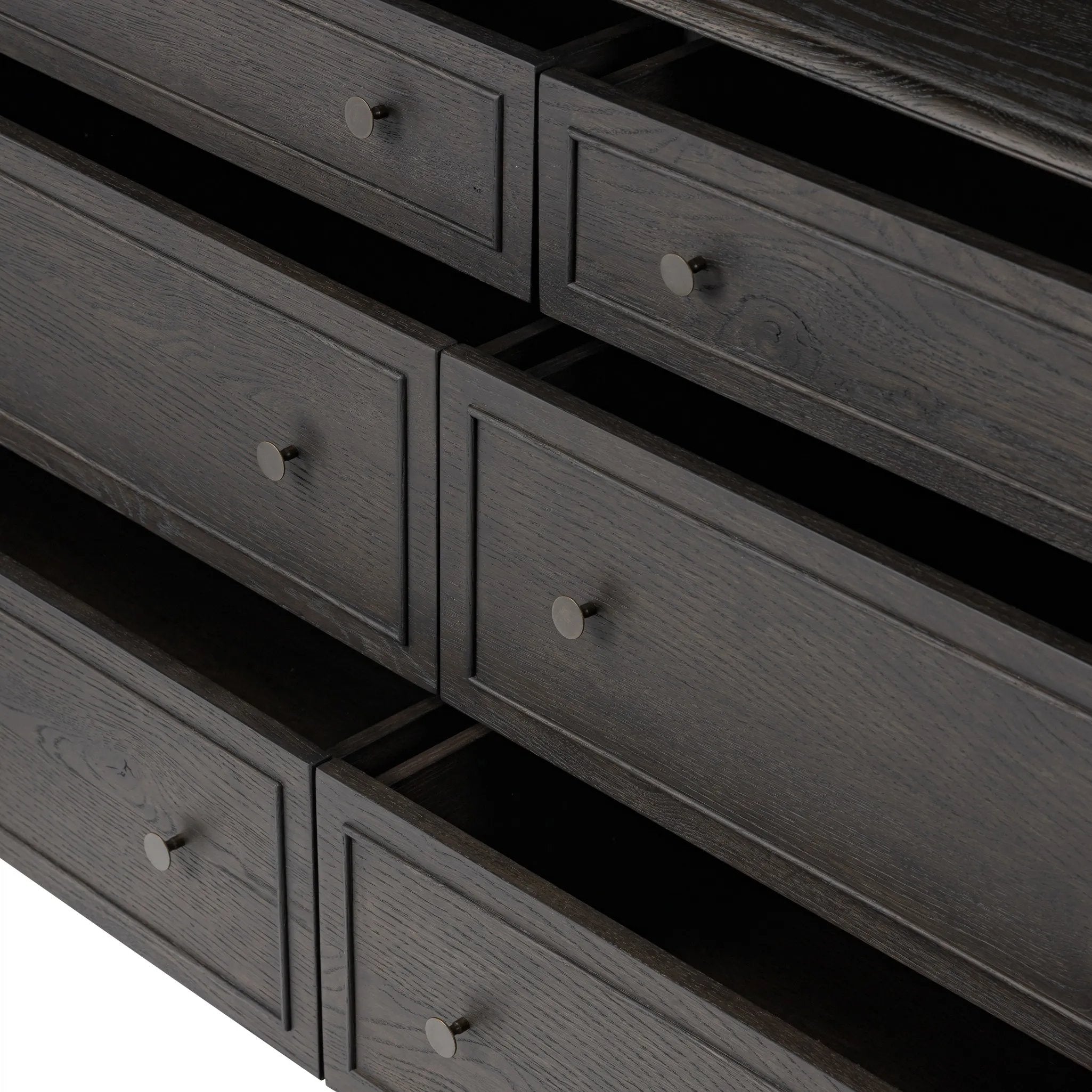 A cleanly shaped six-drawer dresser is crafted from smoked black oak, highlighting the wood's natural grain. Roomy drawers offer plenty of space for bedroom storage, while the slim, tapered legs give the piece a subtle lift, creating a grounded look Amethyst Home provides interior design, new home construction design consulting, vintage area rugs, and lighting in the Los Angeles metro area.