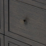 A cleanly shaped six-drawer dresser is crafted from smoked black oak, highlighting the wood's natural grain. Roomy drawers offer plenty of space for bedroom storage, while the slim, tapered legs give the piece a subtle lift, creating a grounded look Amethyst Home provides interior design, new home construction design consulting, vintage area rugs, and lighting in the Monterey metro area.