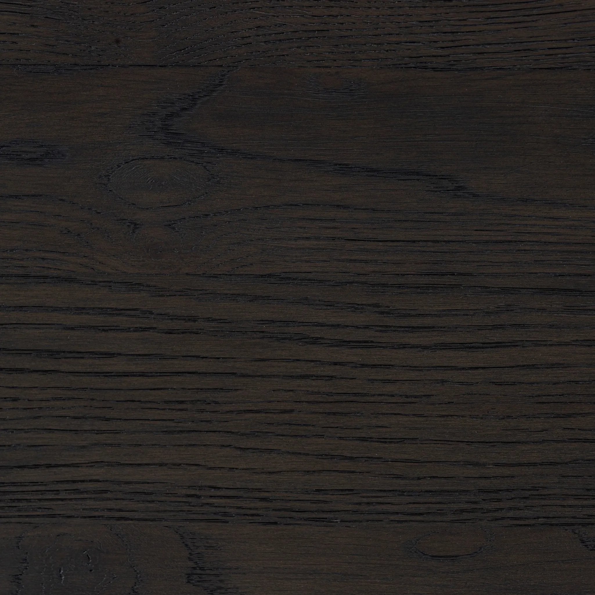A cleanly shaped six-drawer dresser is crafted from smoked black oak, highlighting the wood's natural grain. Roomy drawers offer plenty of space for bedroom storage, while the slim, tapered legs give the piece a subtle lift, creating a grounded look Amethyst Home provides interior design, new home construction design consulting, vintage area rugs, and lighting in the Nashville metro area.