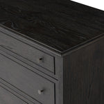 A cleanly shaped six-drawer dresser is crafted from smoked black oak, highlighting the wood's natural grain. Roomy drawers offer plenty of space for bedroom storage, while the slim, tapered legs give the piece a subtle lift, creating a grounded look Amethyst Home provides interior design, new home construction design consulting, vintage area rugs, and lighting in the Newport Beach metro area.