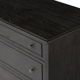 A cleanly shaped six-drawer dresser is crafted from smoked black oak, highlighting the wood's natural grain. Roomy drawers offer plenty of space for bedroom storage, while the slim, tapered legs give the piece a subtle lift, creating a grounded look Amethyst Home provides interior design, new home construction design consulting, vintage area rugs, and lighting in the Newport Beach metro area.
