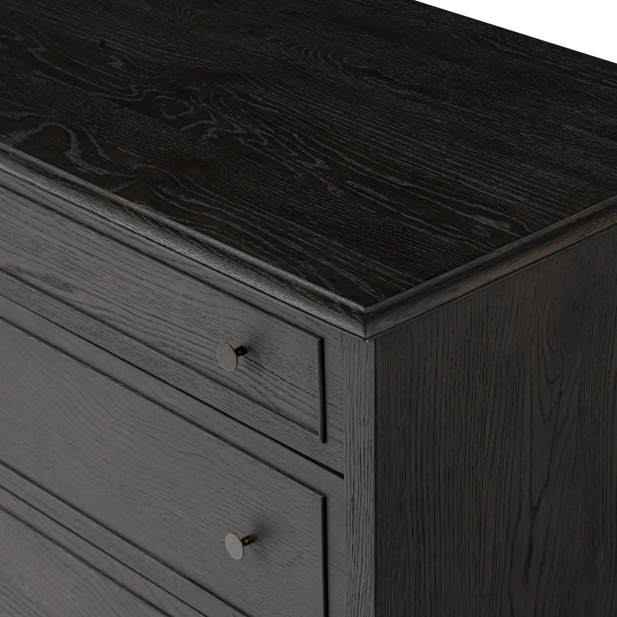 A cleanly shaped six-drawer dresser is crafted from smoked black oak, highlighting the wood's natural grain. Roomy drawers offer plenty of space for bedroom storage, while the slim, tapered legs give the piece a subtle lift, creating a grounded look Amethyst Home provides interior design, new home construction design consulting, vintage area rugs, and lighting in the Newport Beach metro area.