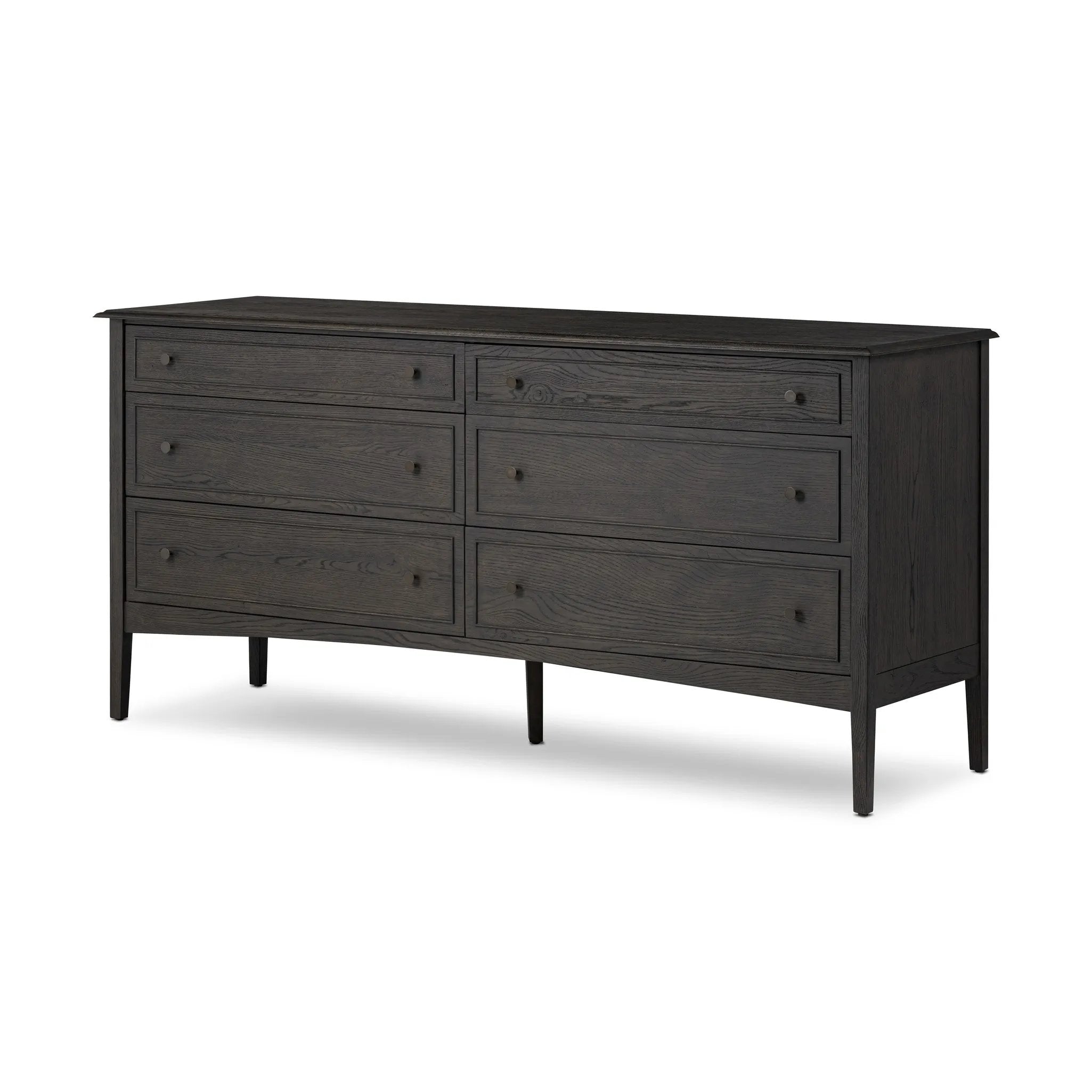 A cleanly shaped six-drawer dresser is crafted from smoked black oak, highlighting the wood's natural grain. Roomy drawers offer plenty of space for bedroom storage, while the slim, tapered legs give the piece a subtle lift, creating a grounded look Amethyst Home provides interior design, new home construction design consulting, vintage area rugs, and lighting in the Park City metro area.