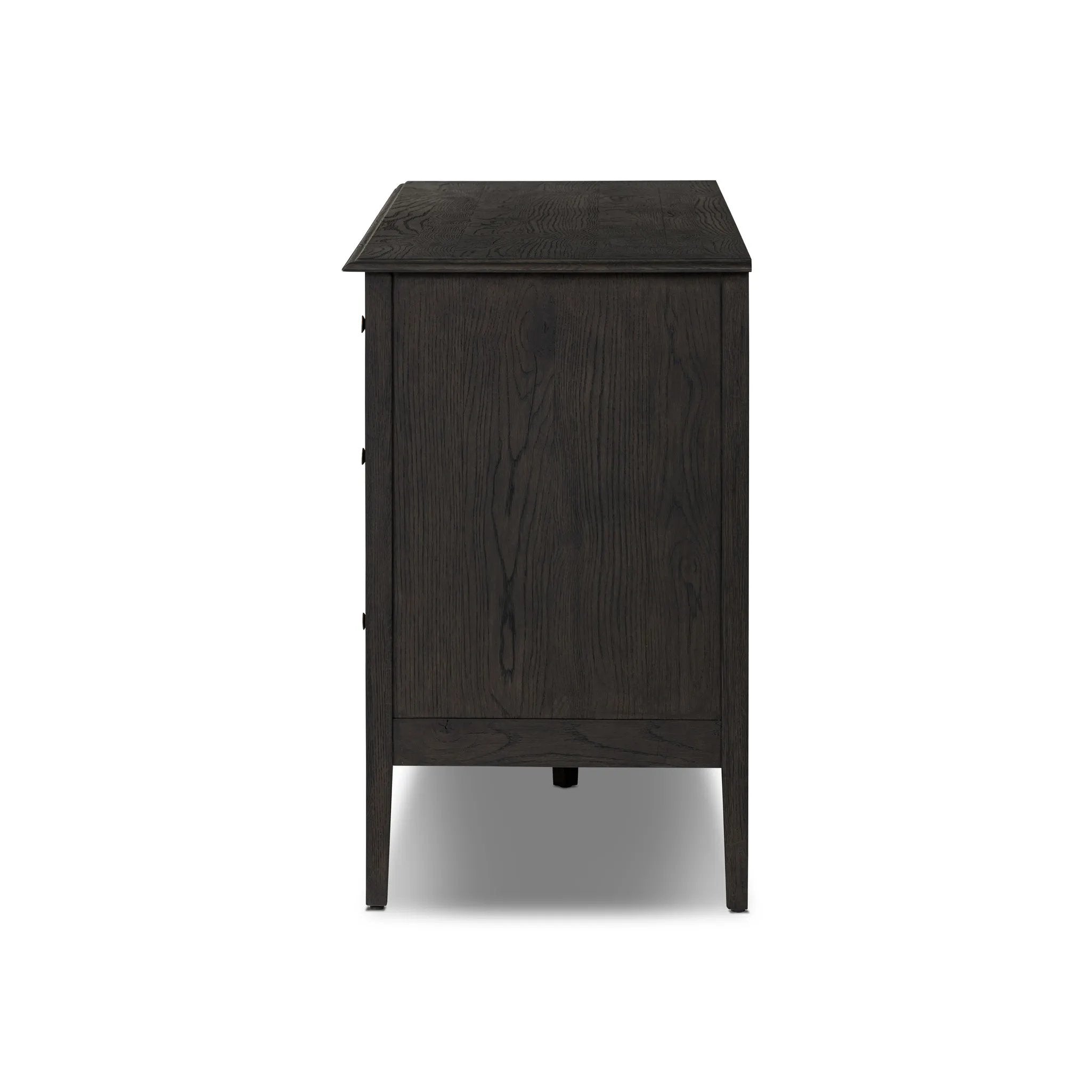 A cleanly shaped six-drawer dresser is crafted from smoked black oak, highlighting the wood's natural grain. Roomy drawers offer plenty of space for bedroom storage, while the slim, tapered legs give the piece a subtle lift, creating a grounded look Amethyst Home provides interior design, new home construction design consulting, vintage area rugs, and lighting in the Salt Lake City metro area.