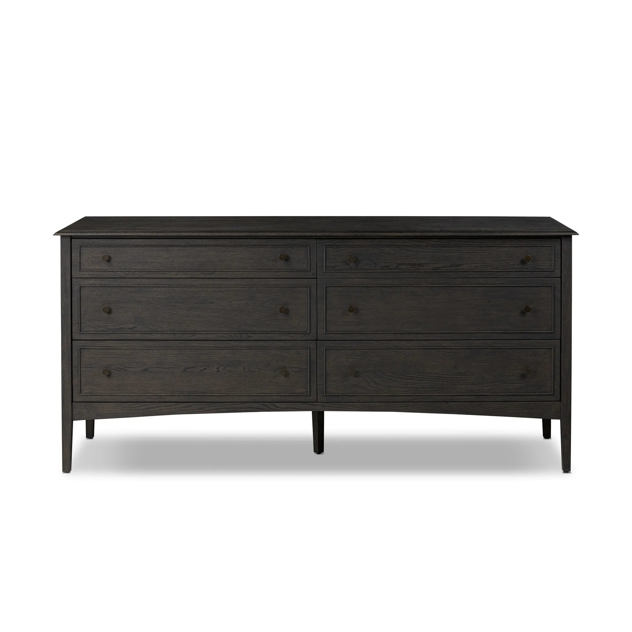A cleanly shaped six-drawer dresser is crafted from smoked black oak, highlighting the wood's natural grain. Roomy drawers offer plenty of space for bedroom storage, while the slim, tapered legs give the piece a subtle lift, creating a grounded look Amethyst Home provides interior design, new home construction design consulting, vintage area rugs, and lighting in the Scottsdale metro area.