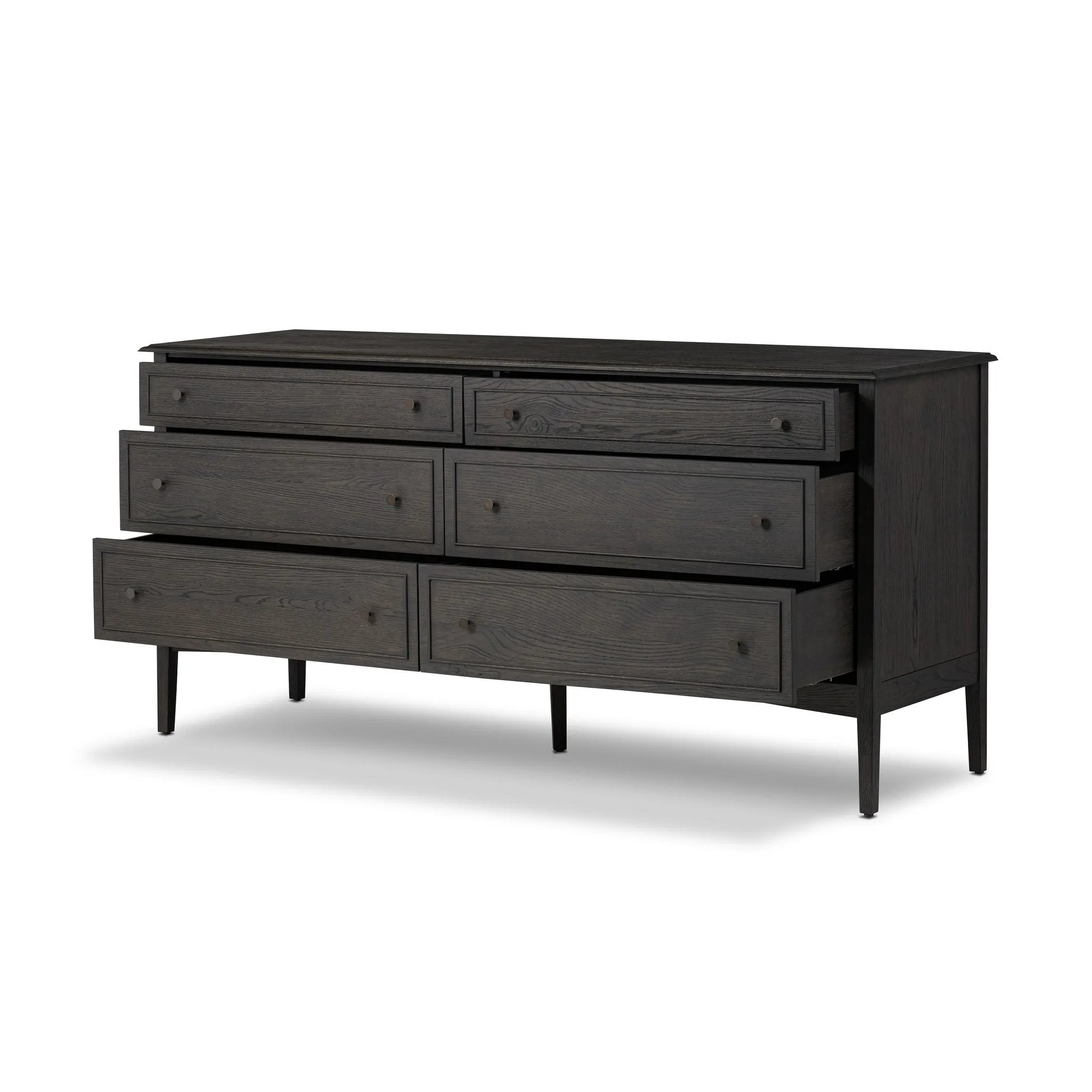 A cleanly shaped six-drawer dresser is crafted from smoked black oak, highlighting the wood's natural grain. Roomy drawers offer plenty of space for bedroom storage, while the slim, tapered legs give the piece a subtle lift, creating a grounded look Amethyst Home provides interior design, new home construction design consulting, vintage area rugs, and lighting in the Winter Garden metro area.