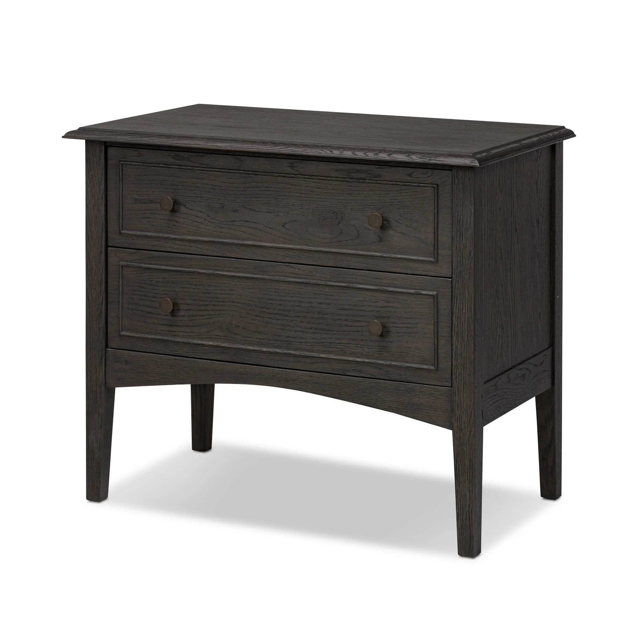 Clean and compact, a two-drawer nightstand is crafted from smoked black oak, showcasing the natural grain of wood. Its scaled-down profile fits perfectly beside the bed. Slim, tapered legs add a touch of lightness Amethyst Home provides interior design, new home construction design consulting, vintage area rugs, and lighting in the Nashville metro area.