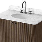This bath vanity is simply shaped to allow the reeded oak to shine. Rounded corners bring softness and allow for a seamless finish, complemented by tapered knob hardware. Finished with a bath-safe sealant for moisture resistance. Designed to accommodate 8”-widespread faucets and standard-size hardware for easy customization. Amethyst Home provides interior design, new home construction design consulting, vintage area rugs, and lighting in the Nashville metro area.