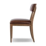 Both modern and traditional, toasted oak frames this high-back, armless dining chair. Finished with a rich brown top-grain leather, with hanging straps affixed to the back Amethyst Home provides interior design, new home construction design consulting, vintage area rugs, and lighting in the Austin metro area.