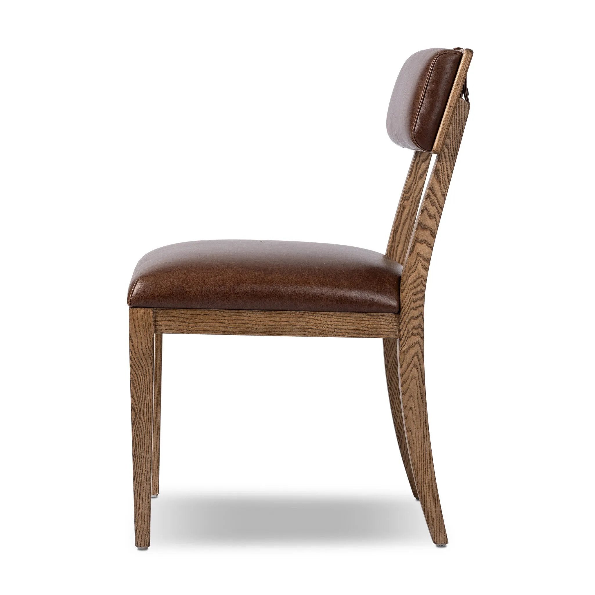 Both modern and traditional, toasted oak frames this high-back, armless dining chair. Finished with a rich brown top-grain leather, with hanging straps affixed to the back Amethyst Home provides interior design, new home construction design consulting, vintage area rugs, and lighting in the Austin metro area.