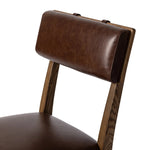 Both modern and traditional, toasted oak frames this high-back, armless dining chair. Finished with a rich brown top-grain leather, with hanging straps affixed to the back Amethyst Home provides interior design, new home construction design consulting, vintage area rugs, and lighting in the Los Angeles metro area.