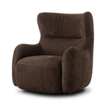 Modern wingback with a twist of barrel back design, this enveloping swivel chair comes with velvety upholstery in a deep brown hue. Deeply cushioned back and seating for maximum comfort, the chair is affixed to a 360-degree swivel base for relaxed lounging Amethyst Home provides interior design, new home construction design consulting, vintage area rugs, and lighting in the Winter Garden metro area.