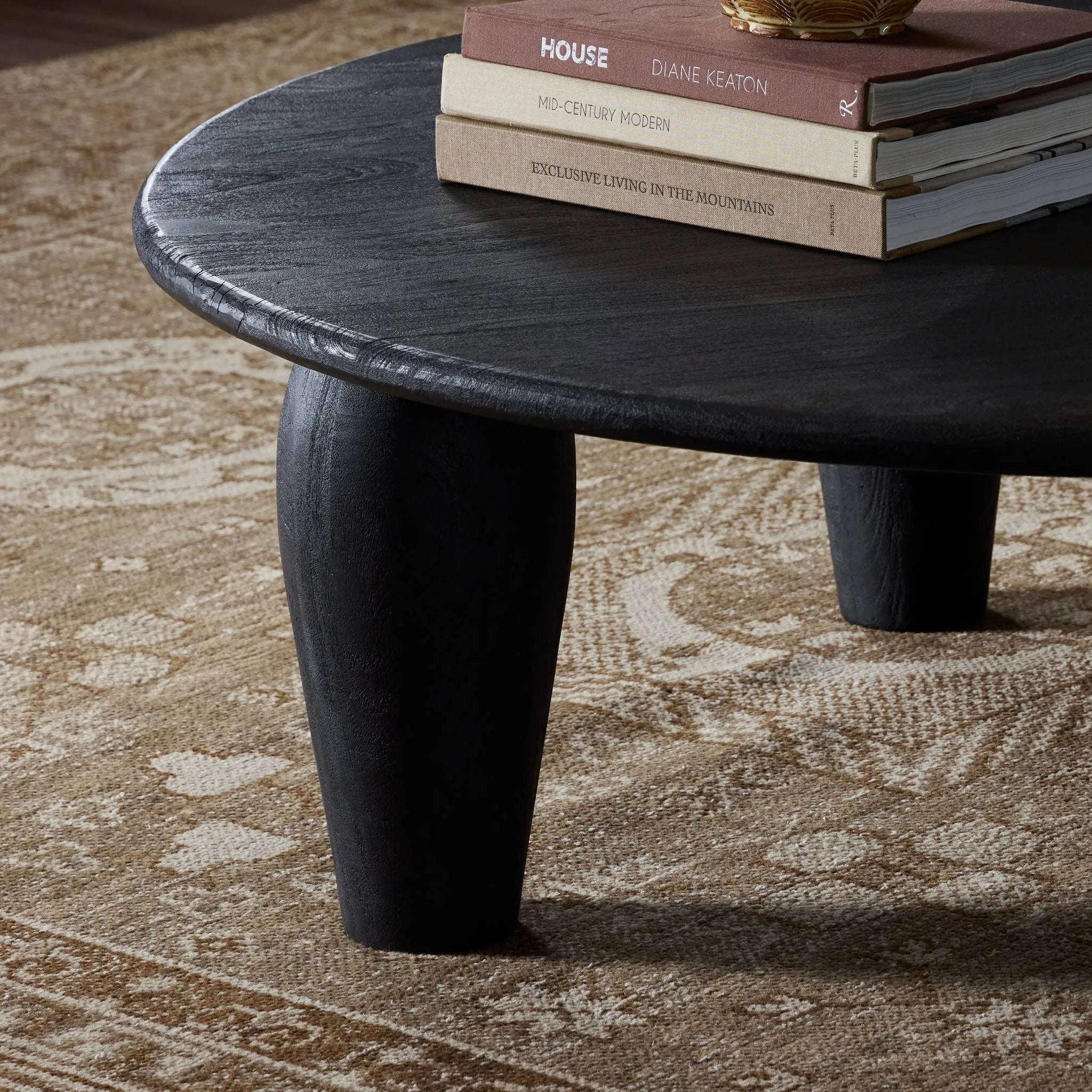 Featuring Maricopa Dark Totem Large Coffee Table by Four Hands at Amethyst Home. Play up proportions. Large, shapely, legs support a rounded tabletop of light black-finished solid reclaimed woods, for a global, organic look and handcrafted feel. Overall Dimensions: 50.00"w x 50.00"d x 16.00"h. Amethyst Home provides interior design, new home construction design consulting, vintage area rugs, and lighting in the Dallas metro area.