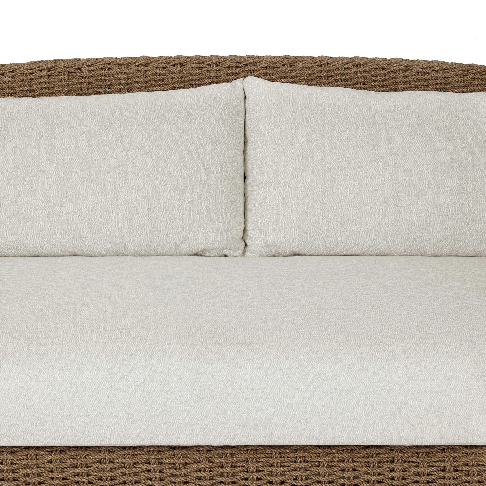 Twisted faux rattan is double twisted for a chunky feel, inspired by traditional coastal designs. The fully woven, cambelback silhouette of this outdoor sofa adds visual interest, with high-end, linen-like upholstery bringing subtle contrast to the seat cushions. Amethyst Home provides interior design, new home construction design consulting, vintage area rugs, and lighting in the Kansas City metro area.