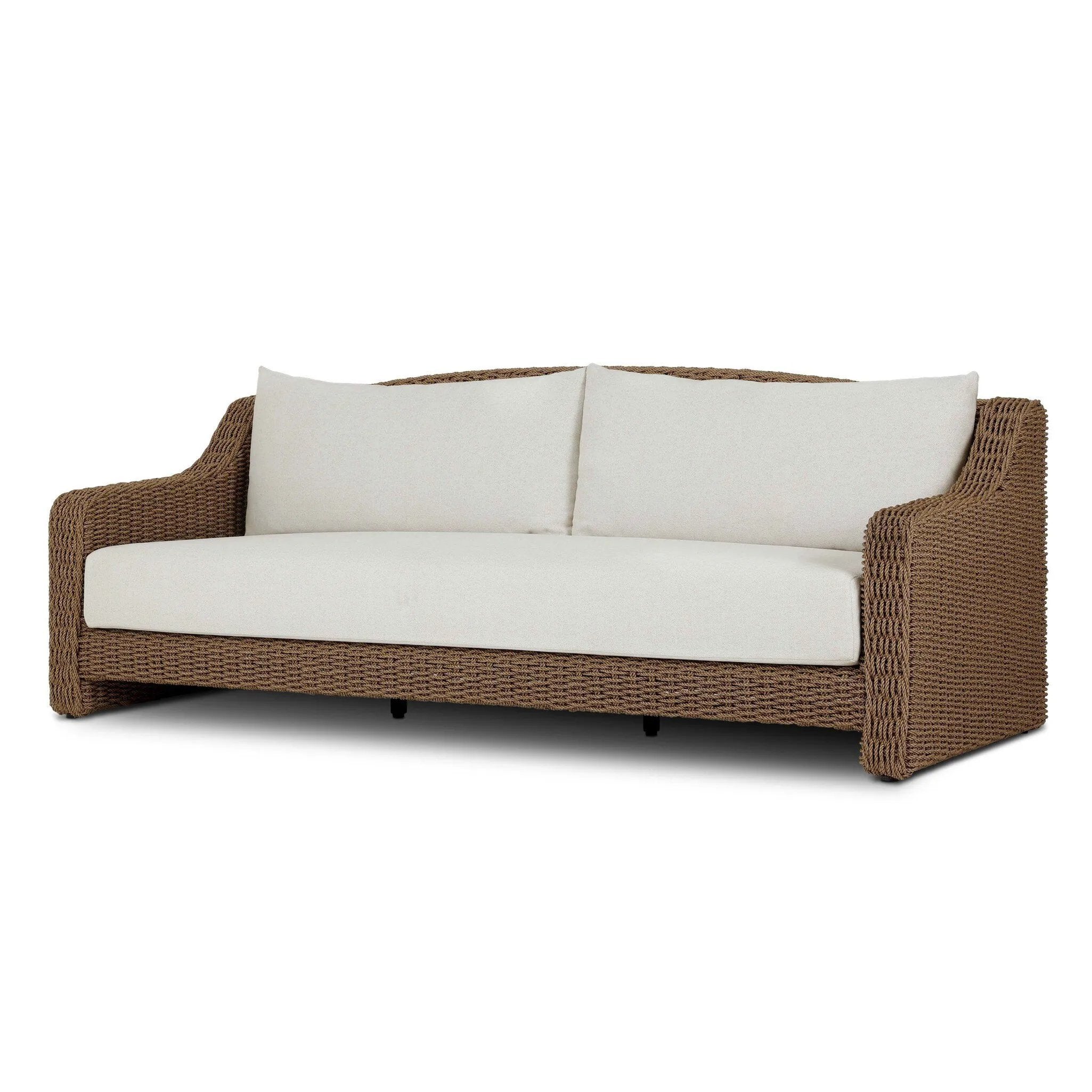 Twisted faux rattan is double twisted for a chunky feel, inspired by traditional coastal designs. The fully woven, cambelback silhouette of this outdoor sofa adds visual interest, with high-end, linen-like upholstery bringing subtle contrast to the seat cushions. Amethyst Home provides interior design, new home construction design consulting, vintage area rugs, and lighting in the Tampa metro area.