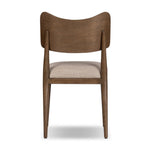 An armless dining style pairs a slim profile and curved back, for a beautifully contoured look. Framed by tan-finished solid oak featuring a center cutout, a seat cushion upholstered in high-performance fabric crafts a comfortable seat perfect for everyday dining. Amethyst Home provides interior design, new home construction design consulting, vintage area rugs, and lighting in the Dallas metro area.