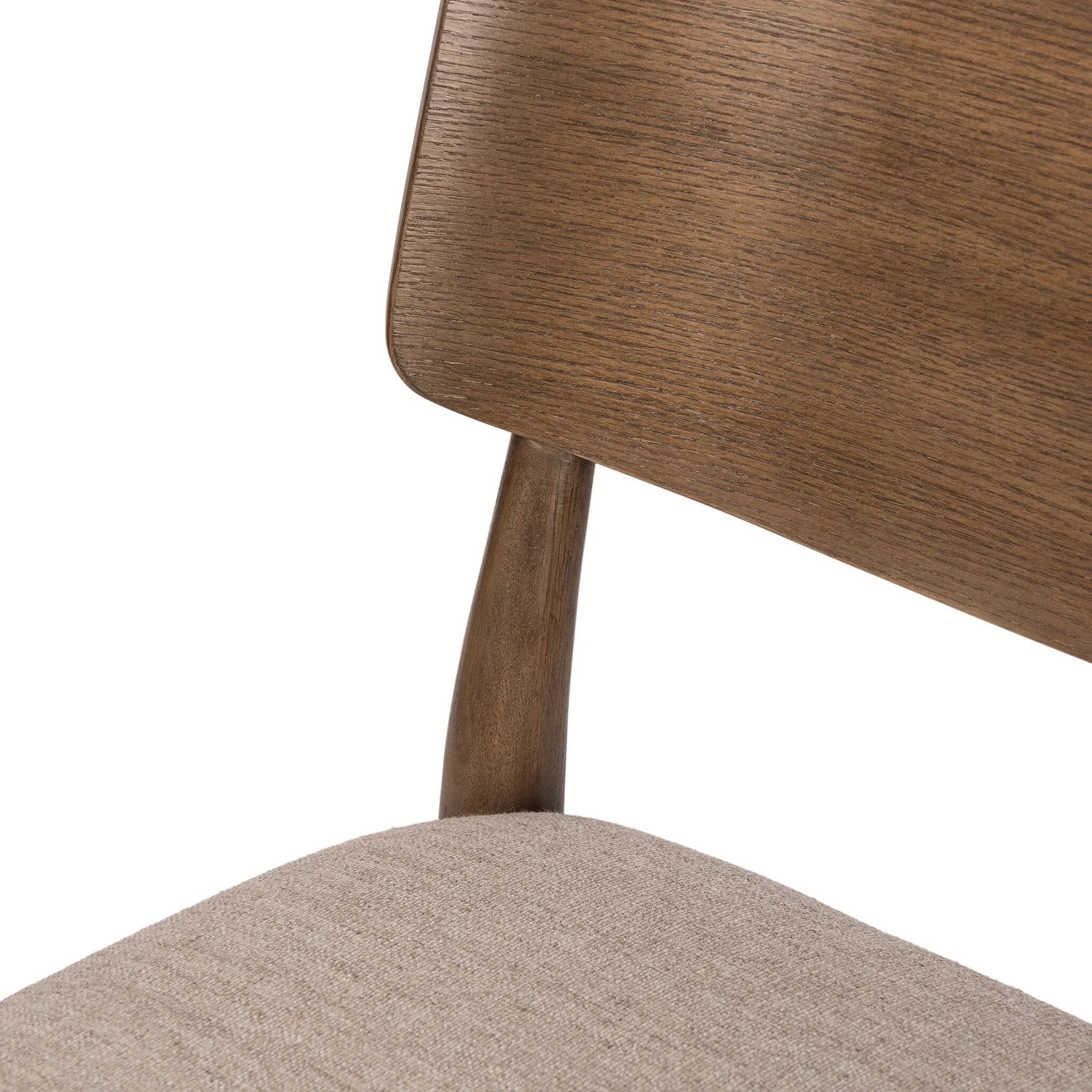 An armless dining style pairs a slim profile and curved back, for a beautifully contoured look. Framed by tan-finished solid oak featuring a center cutout, a seat cushion upholstered in high-performance fabric crafts a comfortable seat perfect for everyday dining. Amethyst Home provides interior design, new home construction design consulting, vintage area rugs, and lighting in the San Diego metro area.