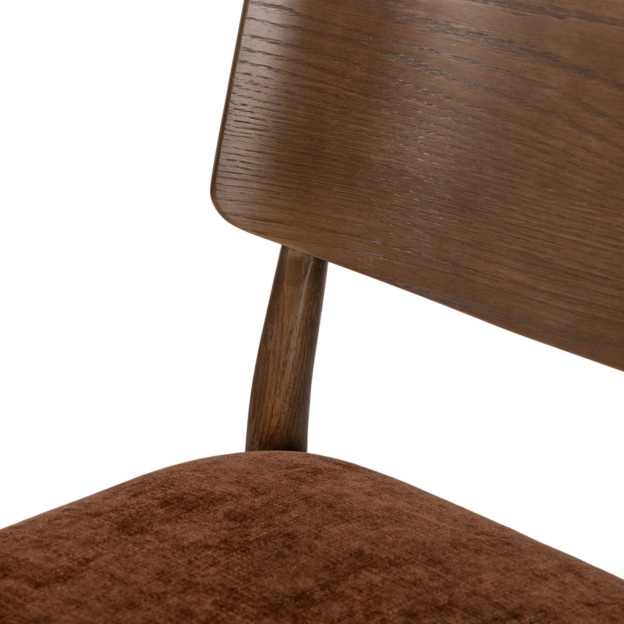 An armless dining style pairs a slim profile and curved back, for a beautifully contoured look. Framed by dark-finished solid oak featuring a center cutout, velvety, rust-colored cushioning crafts a comfortable seat perfect for everyday dining Amethyst Home provides interior design, new home construction design consulting, vintage area rugs, and lighting in the Salt Lake City metro area.