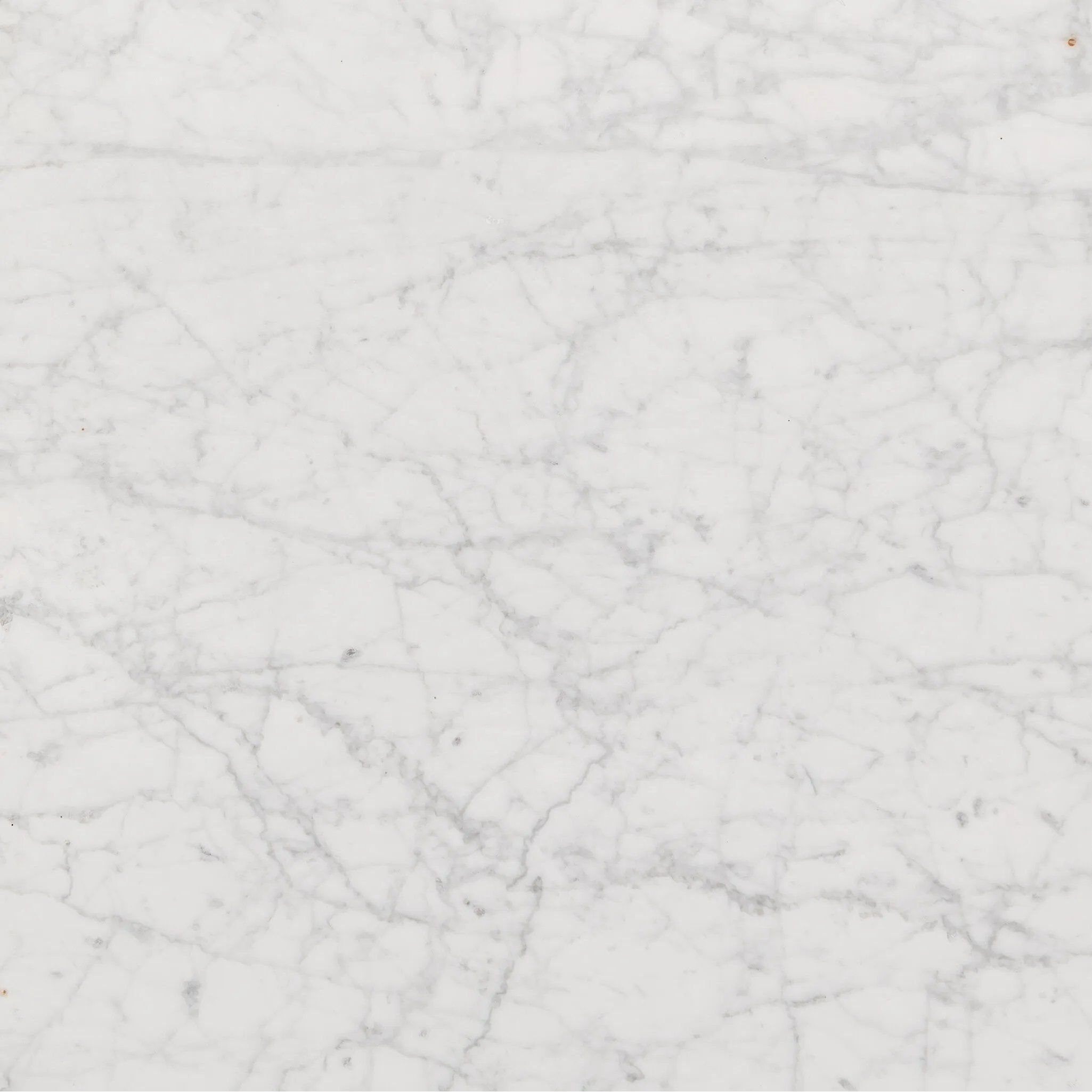 A white Carrara marble slab, rich with veining and movement. Supported by a wooden plinth, marble takes the spotlight in a design that's simple and sophisticated at once.Collection: Hughe Amethyst Home provides interior design, new home construction design consulting, vintage area rugs, and lighting in the Austin metro area.