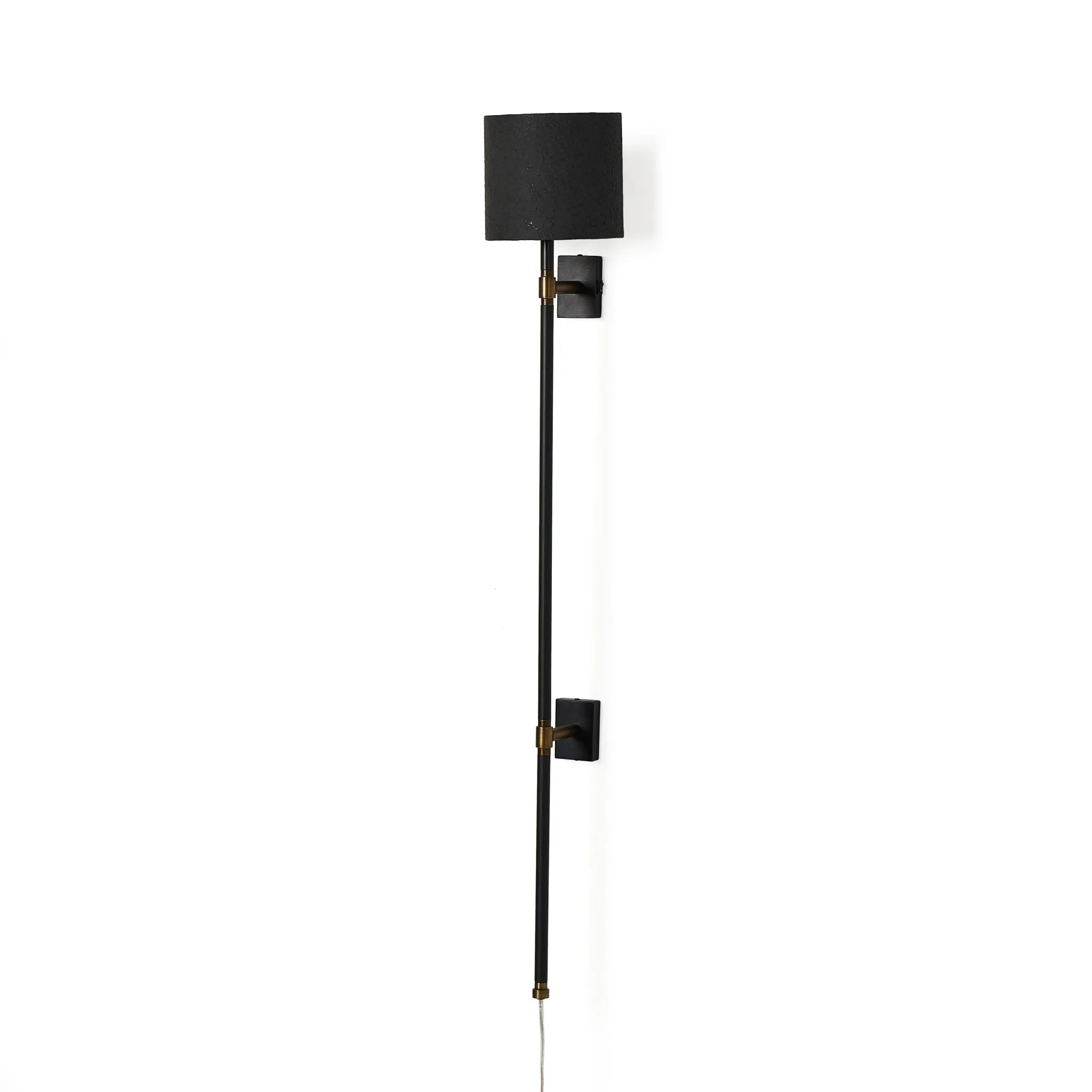 Housed behind a curved black shade, light beams with a soft glow both upward and downward from this plug-in sconce.  A  slim pole to hide the cord and a convenient switch on the backplate create a seamless look Amethyst Home provides interior design, new home construction design consulting, vintage area rugs, and lighting in the Park City metro area.