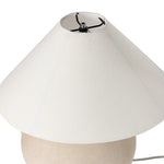Featuring Mays Light Sand Porcelain Table Lamp by Four Hands at Amethyst Home. Inspired by vintage clay jars, a light sand-colored talavera lamp with handle-like detailing pairs with a tapered linen shade in a versatile ivory. Overall Dimensions: 22.00"w x 22.00"d x 21.00"h
 Shop this lamp at Amethyst - https://www.amethysthome.com/products/mays-light-sand-. Amethyst Home provides interior design, new home construction design consulting, vintage area rugs, and lighting in the San Diego metro area.