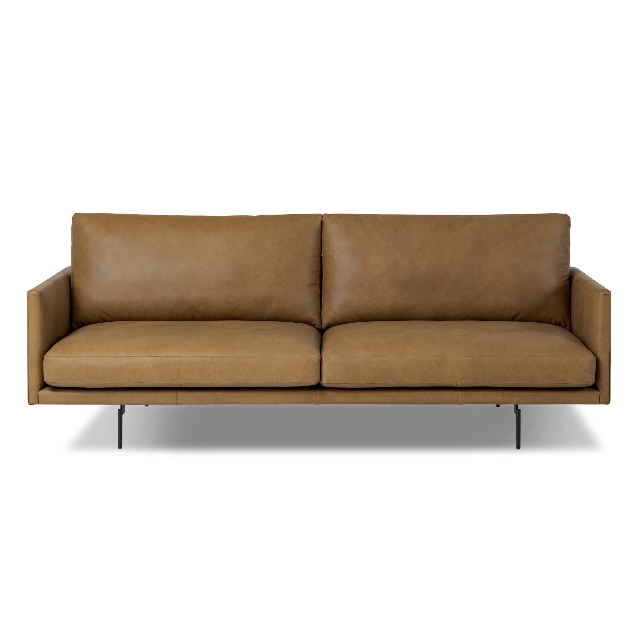 A minimalist form to redefine contemporary seating. Made from tan top-grain leather with a slim profile, expert tailoring and plush cushions for comfort. Sleek metal legs and compact sizing make this piece a versatile anchor for smaller living spaces Amethyst Home provides interior design, new home construction design consulting, vintage area rugs, and lighting in the Washington metro area.