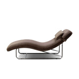 Contoured for comfort, this minimalist chaise is fixed with ideal ergonomics so you can simply sit back and unwind. Inspired by 1960s European design, the chaise blends a utilitarian aesthetic with high-quality tufting, stainless-steel framing, and smooth upholstery. The adjustable headrest is secured by a metal closure and magnetic strip. Amethyst Home provides interior design, new home construction design consulting, vintage area rugs, and lighting in the San Diego metro area.