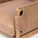 Safari inspiration meets zen aspirations. A cylindrical frame is crafted, smoothed and rounded from solid ash wood. Includes two loose feather-blend cushions covered in subtly distressed thick cut leather in a neutral taupe hue for a monochromatic look Amethyst Home provides interior design, new home construction design consulting, vintage area rugs, and lighting in the Charlotte metro area.